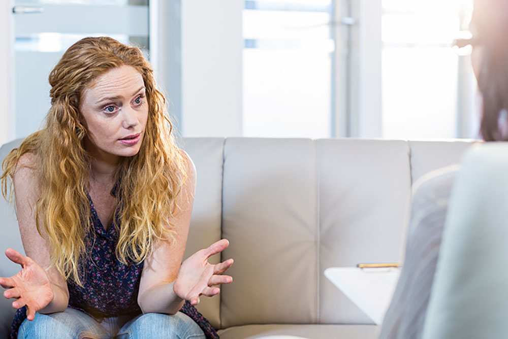 Woman on sofa having counselling